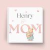 Book cover with a bear holding a baby and 'Henry & Mom' text on a pink background