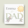 Children's book titled 'Emma & Dad' with illustrations of a hippo and a sun on a white background.