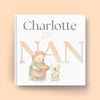 Book cover with illustration of a bear and a child, and text 'Charlotte & Nan' on a beige background