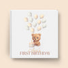 Children's birthday book with a teddy bear and balloons design on a beige background