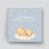 Book with a teddy bear illustration and text on a light blue background